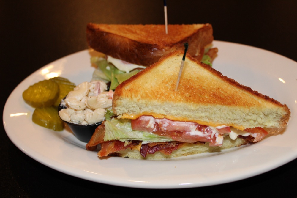 Toasted club sandwich with a pickle spear