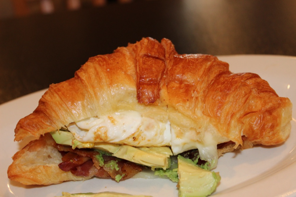 Croissant sandwich with bacon and egg